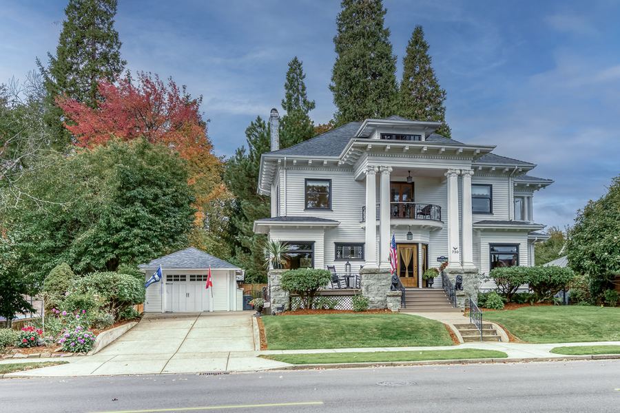 The house from the street, with autumn trees and the garage